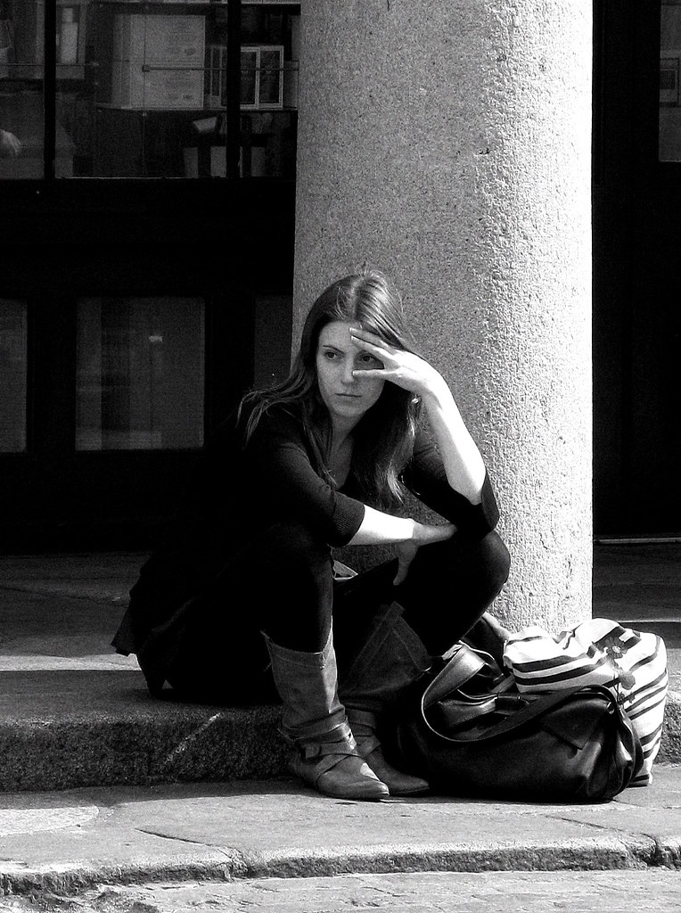 A person waiting by the roadside