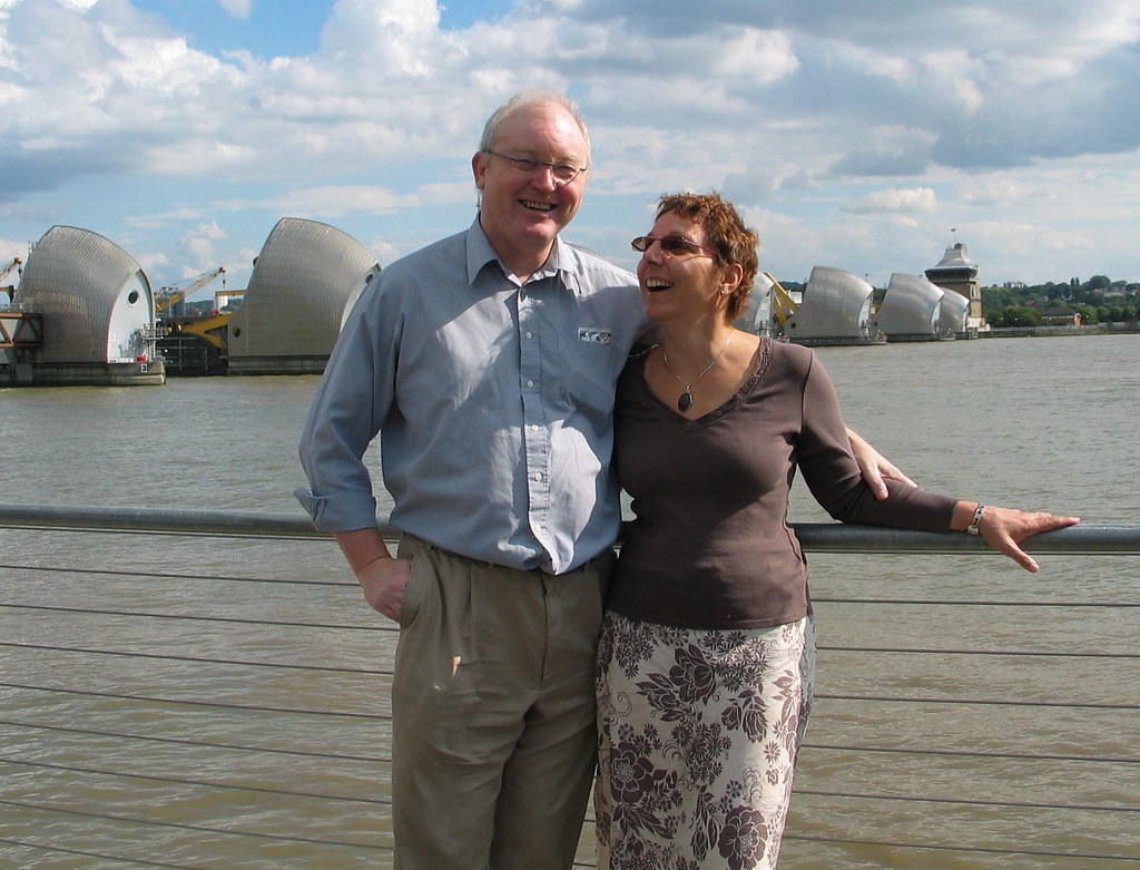 A happy couple laughing together at home