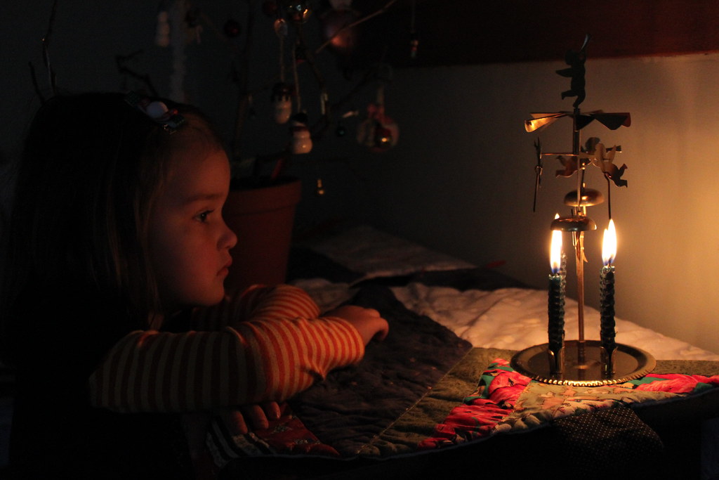A candle burning in a dark room
