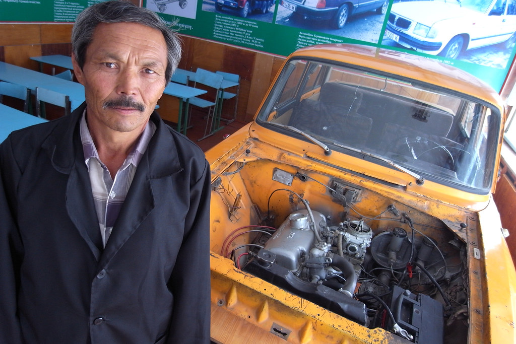 A mechanic working on a car engine