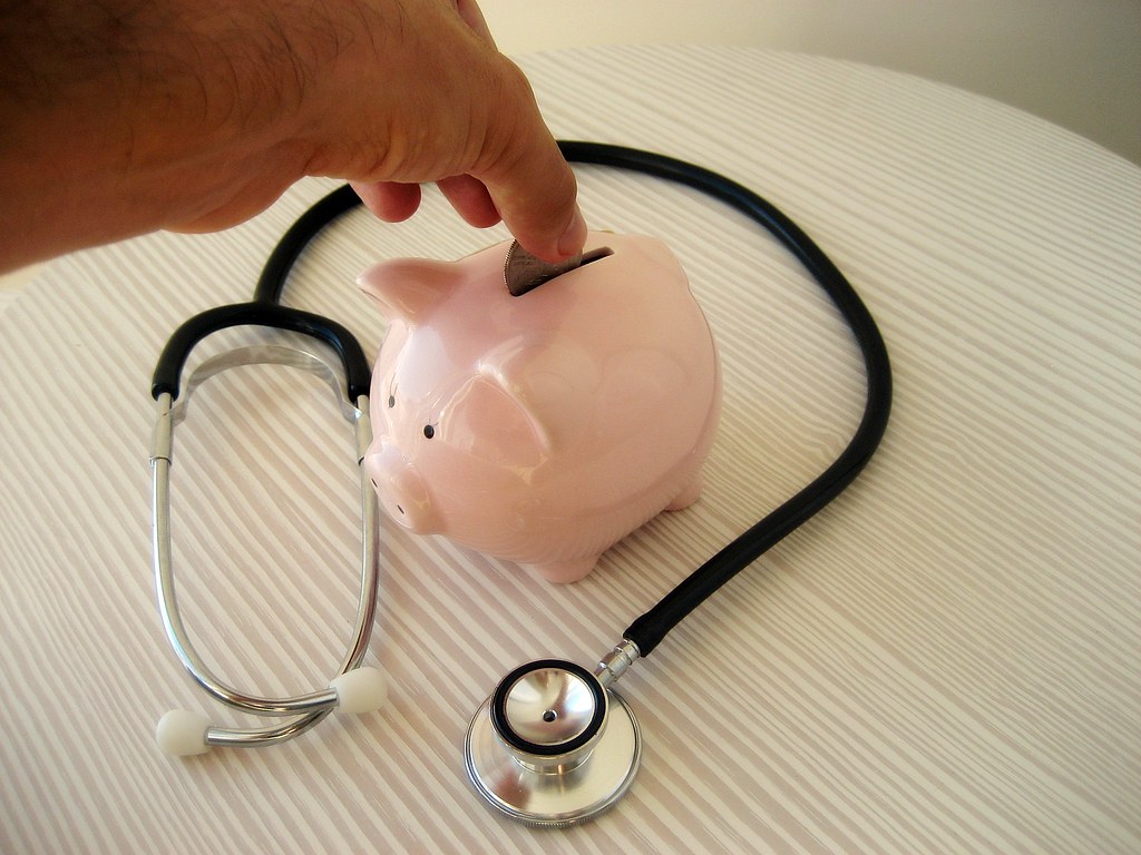 A piggy bank with coins beside it