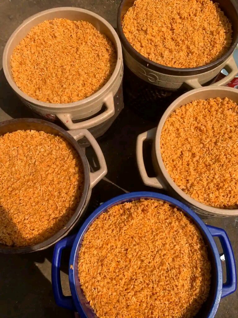 A big tray of party jollof rice at a Nigerian celebration