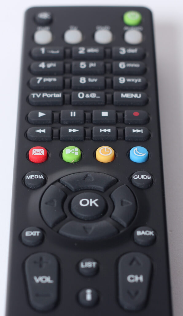 A television remote control on a sofa